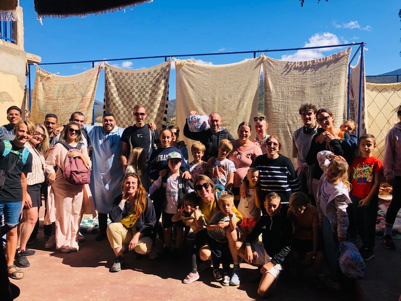 A visiting group with rugs drying in the mountain sun
