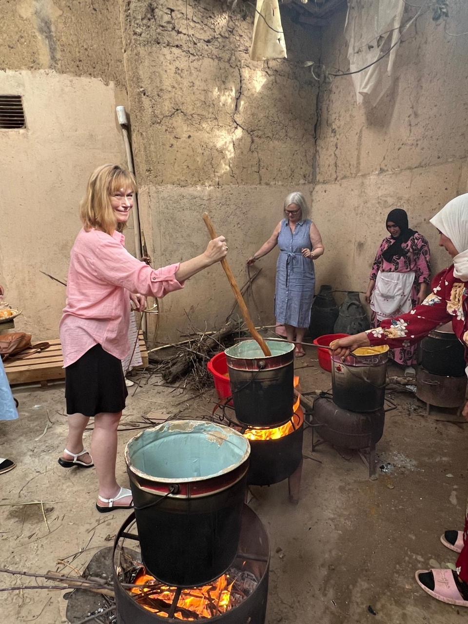 Guests stirring the dye pots over open fires